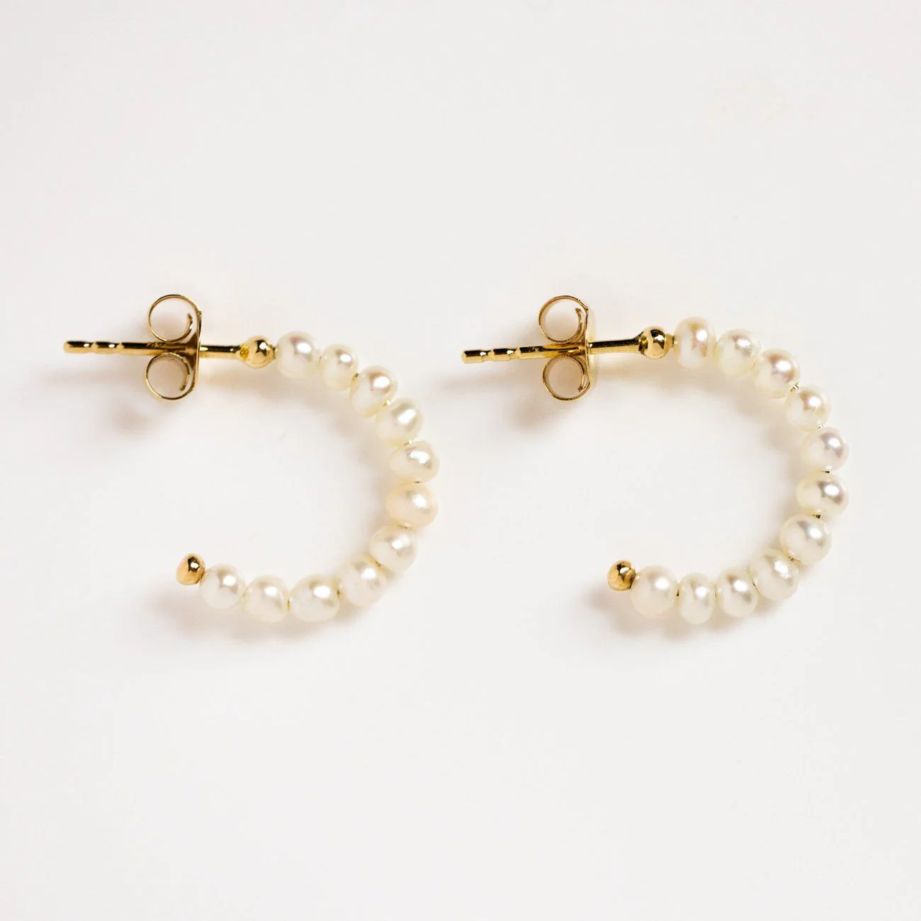 Solid Gold Simple Pearl Huggie Hoops - Image 4